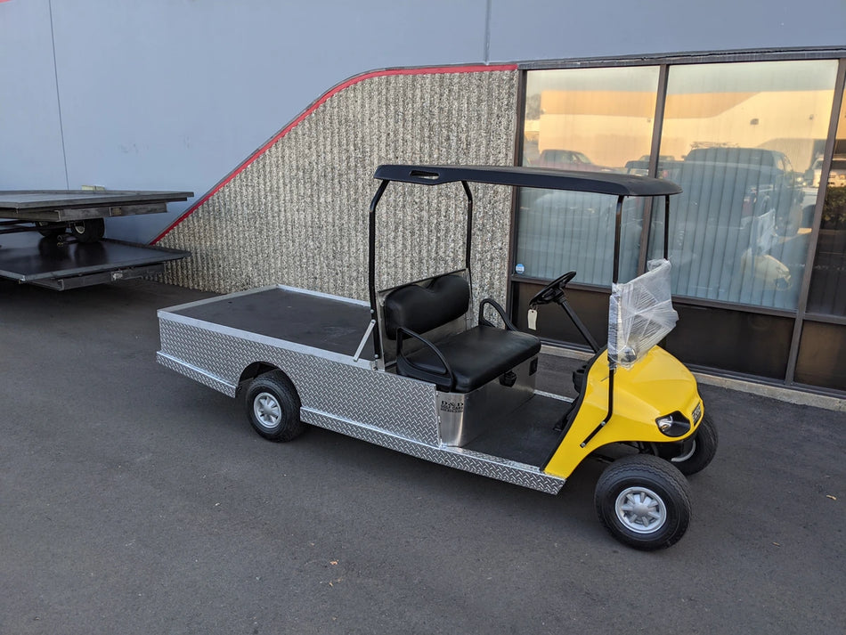 EZGO-TXT-AL-FLAT-72 6 FOOT ALUMINUM BED FLATBED CONVERSION golf cart with a flatbed cargo area, featuring aluminum construction and custom fabrication for golf carts.