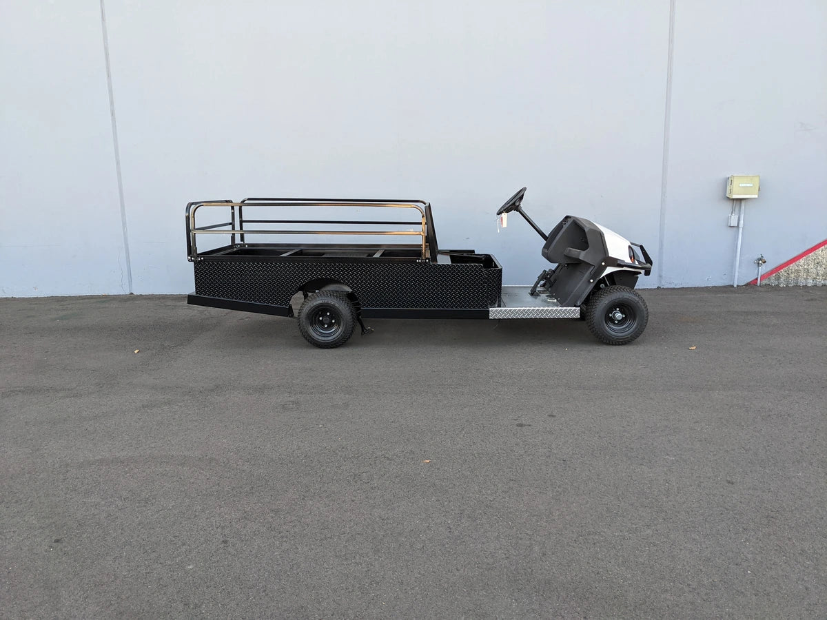 CUSH-800-ST-FLAT-72 CUSHMAN HAULER 800 CART STRETCHED INTO 6′ FLATBED featuring custom fabrication with flatbed cargo design and drop rails for utility and specialty golf cart use.