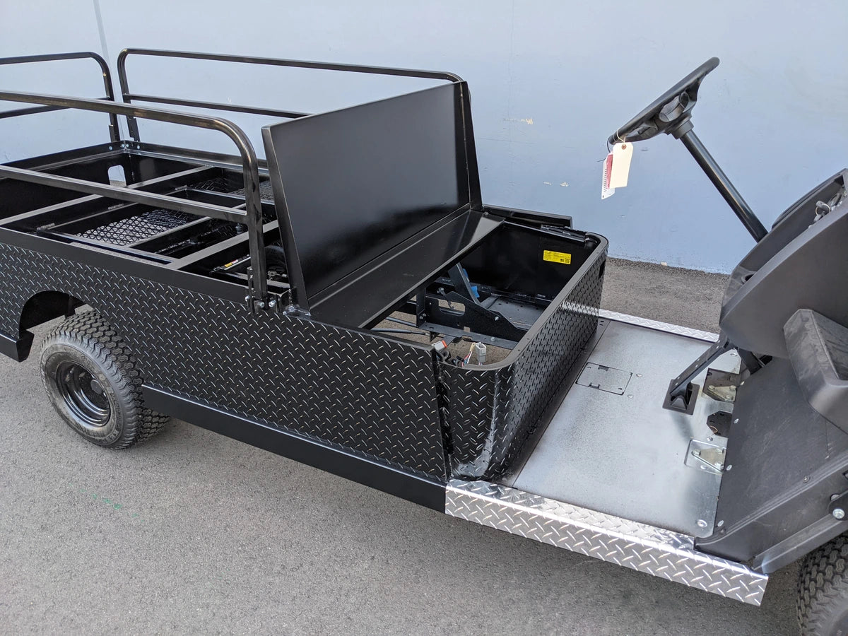 CUSH-800-ST-FLAT-72 CUSHMAN HAULER 800 CART STRETCHED INTO 6′ FLATBED with custom fabrication featuring a black diamond plate flatbed, cargo area, and utility box for golf cart accessories.