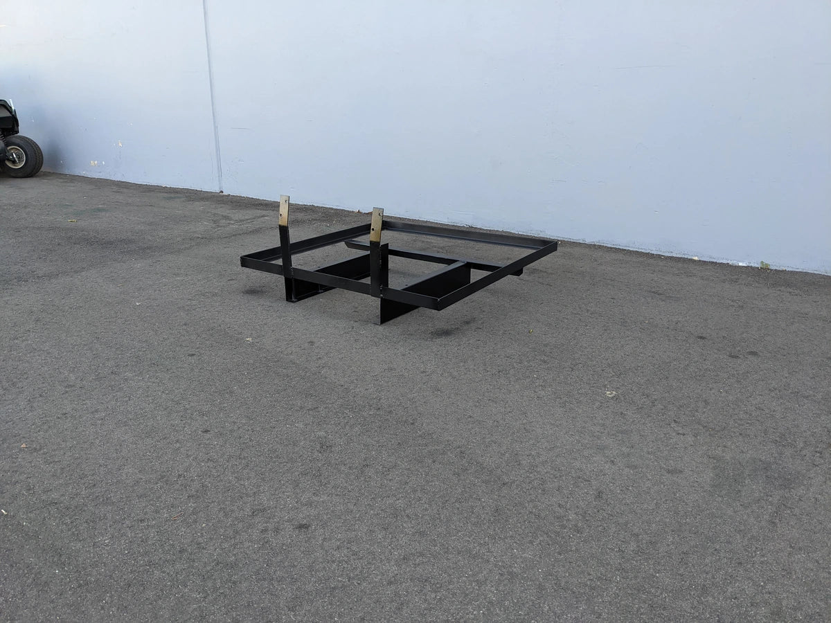 EZGO-TXTMED-DECK44X44 EZ GO TXT AND MEDALIST DIAMOND PLATE STEEL UTILITY DECK 44″ X 44″ custom fabrication for golf carts shown as black steel frame on pavement near wall.