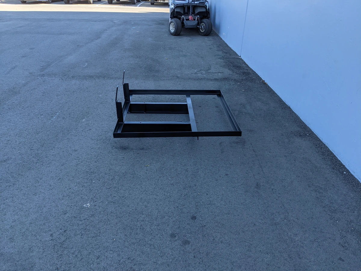 EZGO-TXTMED-DECK44X44 EZ GO TXT AND MEDALIST DIAMOND PLATE STEEL UTILITY DECK 44″ X 44″ custom fabrication for golf carts shown as a steel frame flatbed on pavement near a golf cart.