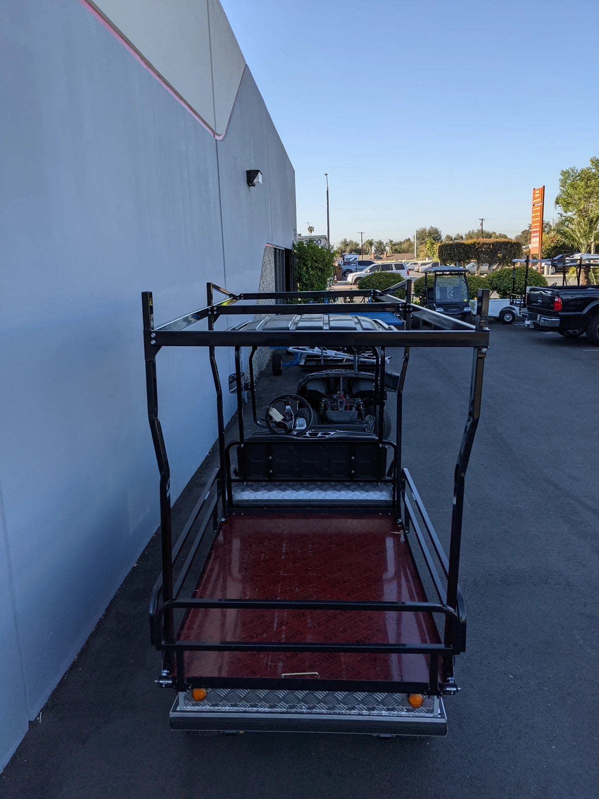 EVO-TURF-44X120-TLRI Top Mount Ladder Rack for mounting inside the bed of an Evolution Turfman 1000, custom fabricated for golf carts, shown installed on a golf cart flatbed with black metal framing.