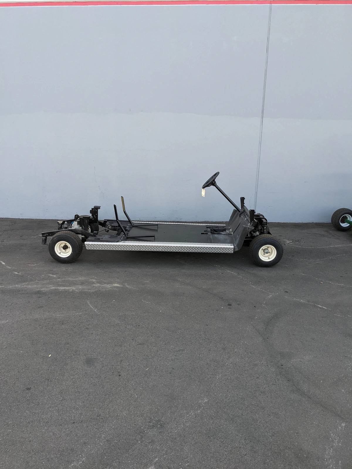 Chassis frame and steering assembly of EZGO-RXV-PS6-4F+2B EZGO RXV 6 PASSENGER CONVERSION showing custom fabrication designed for golf carts.