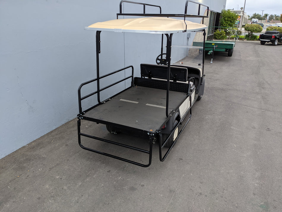 CUSH-SHUTTLE2-DROP-RAILS CUSHMAN SHUTTLE 2 DROP RAIL SET installed on golf cart with flatbed cargo area, custom fabrication for golf carts, featuring durable black metal rails and canopy support.