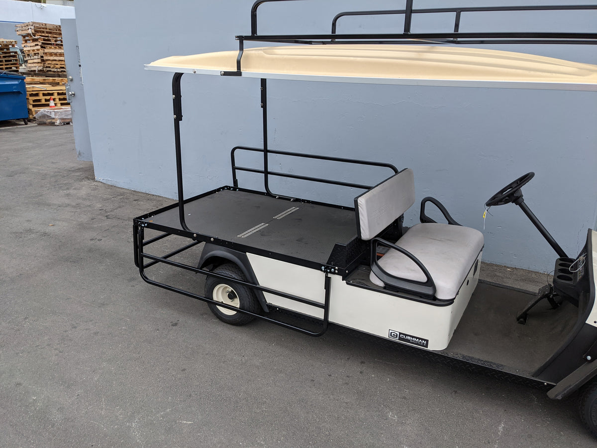 Golf cart fitted with CUSH-SHUTTLE2-DROP-RAILS CUSHMAN SHUTTLE 2 DROP RAIL SET custom fabricated for specialty golf cart beds and cargo hauling.