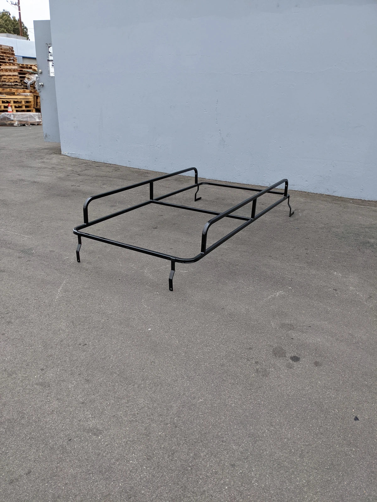 Black metal frame custom fabrication designed as the CUSH-SHUTTLE2-84LR CUSHMAN SHUTTLE 2 LADDER RACK for golf cart accessories and utility cargo transport.