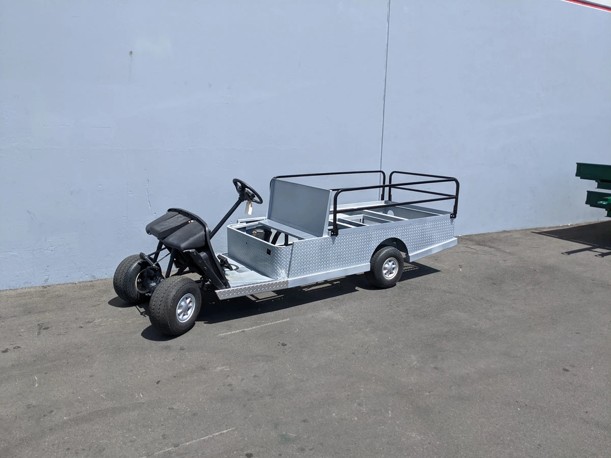 EZGO-TXT-ST-FLAT-72 6 FT FLATBED CONVERSION FOR EZ GO TXT golf cart featuring custom fabrication with a durable flatbed, utility cargo area, and reinforced rails for versatility and heavy-duty use.