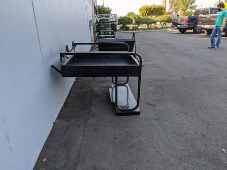 EZGO-RXV-SB-COMBO EZ GO RXV HEAVY-DUTY SEAT BOX COMBO mounted on a wall outdoors, featuring a sturdy black metal frame designed for custom fabrication on golf carts.