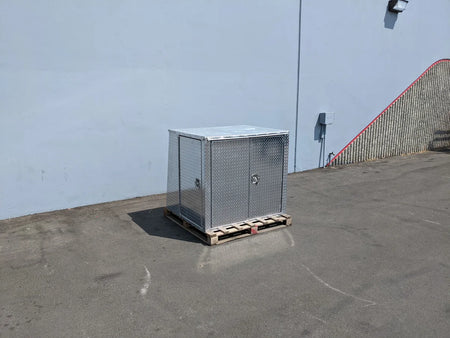 YAM-UMAX-CARGO42X48X42-4D Locking Cargo Box with Doors on Three Sides made of metal, placed on a wooden pallet outdoors, designed for custom fabrication for golf carts.