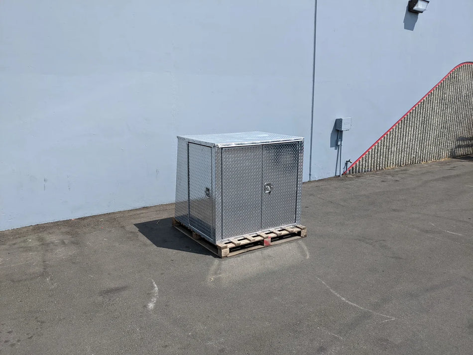 YAM-UMAX-CARGO42X48X42-4D Locking Cargo Box with Doors on Three Sides made of metal, placed on a wooden pallet outdoors, designed for custom fabrication for golf carts.