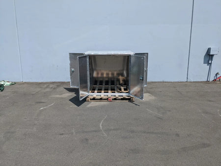 YAM-UMAX-CARGO42X48X42-4D Locking Cargo Box with Doors on Three Sides shown open on a pallet in an outdoor industrial setting, custom fabrication for golf carts.