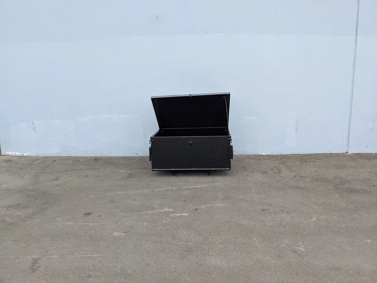 Black heavy-duty lockable cargo box with a diamond plate pattern, open lid, custom fabrication for golf carts, identified as EZGO-TXT-CARGO31 EZ GO TXT LOCKING CARGO BOX.
