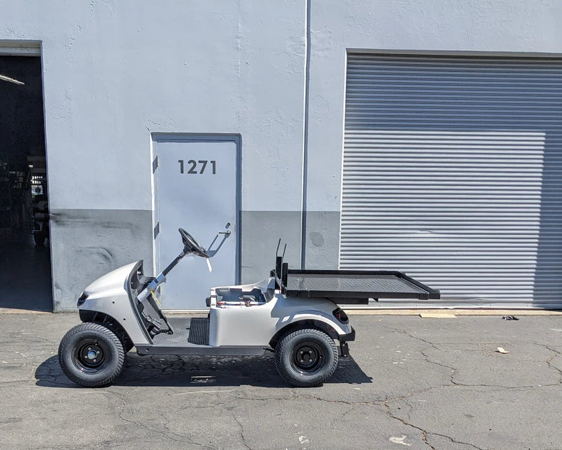 EZGO-TXTVAL-DECK48X48 EZ GO TXT, VALOR, AND MEDALIST DIAMOND PLATE STEEL UTILITY DECK 48″ X 48″ WITH STAKE POCKETS installed on a white golf cart for custom fabrication for golf carts.