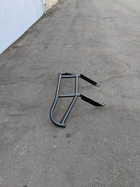 Black metal TOM-EMERGE-E2-BG TOMBERLIN EMERGE E2 BRUSH GUARD designed as custom fabrication for golf carts, shown on asphalt surface.