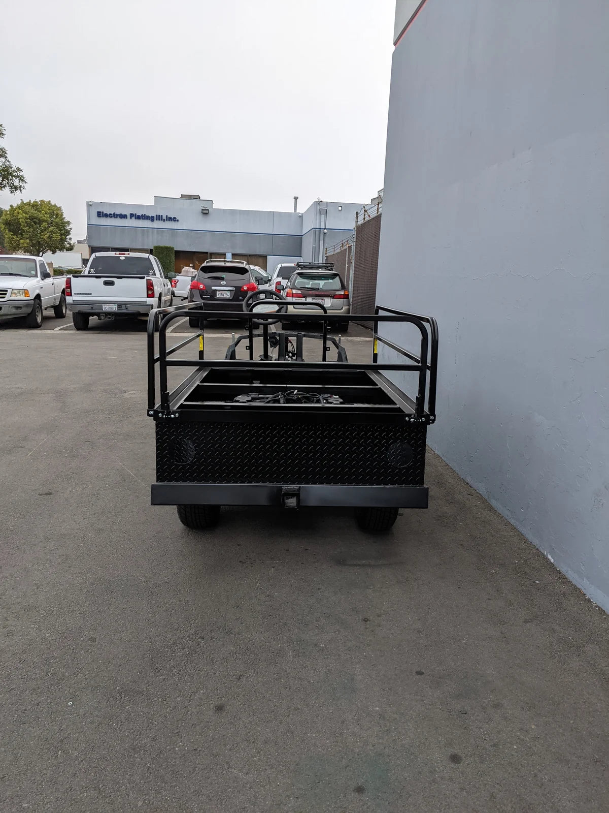Rear view of the YAM-DRIVE2-ST-FLAT-72 YAMAHA DRIVE 2 6FT FLATBED CONVERSION showing a custom flatbed with metal railing designed for specialty golf cart bed applications and cargo hauling.
