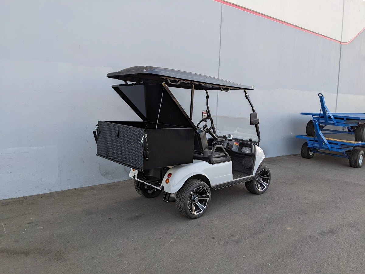 Golf cart fitted with EVO-CLASSIC-CARGO31 EVOLUTION CLASSIC LOCKING CARGO BOX open to show storage space, custom fabrication for golf carts, designed for cargo and utility use.