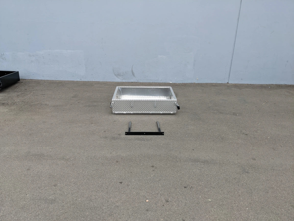 EZGO-RXV-UTIL31A EZ GO RXV ALUMINUM DIAMOND PLATE UTILITY BOX shown on pavement with metal mounting bracket, custom fabrication for golf carts, suitable for cargo and utility storage.