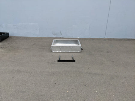 EZGO-RXV-UTIL31A EZ GO RXV ALUMINUM DIAMOND PLATE UTILITY BOX shown on pavement with metal mounting bracket, custom fabrication for golf carts, suitable for cargo and utility storage.