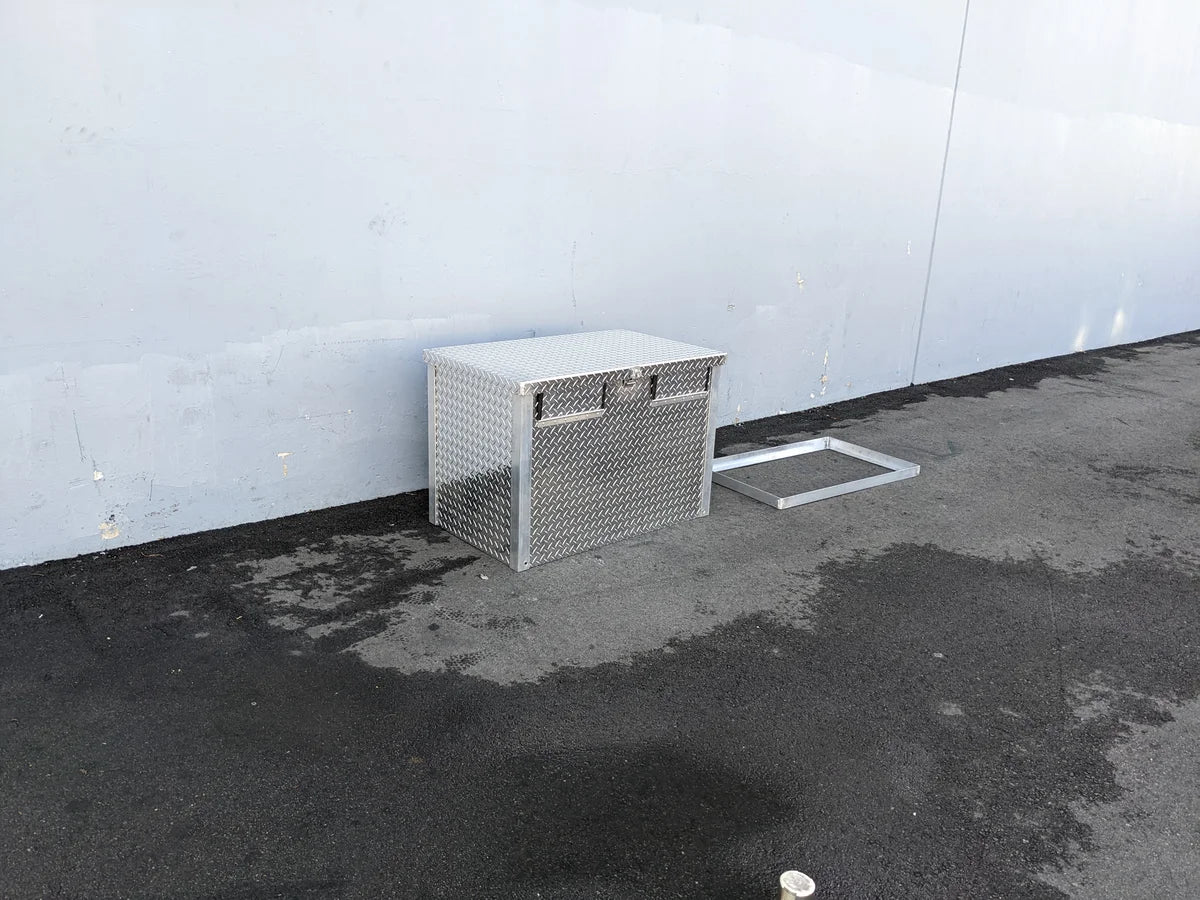 TB-40X24X28-2AD-ABF Aluminum Toolbox with a diamond plate design, shown outdoors on asphalt, custom fabrication for golf carts, suitable for cargo and utility storage.