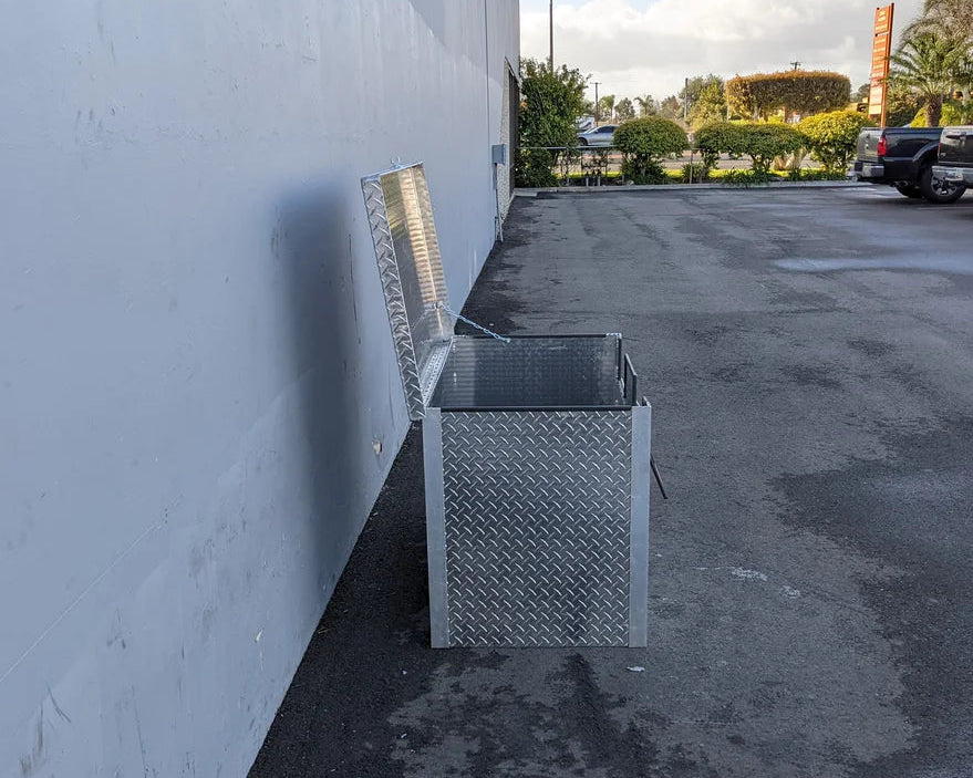 Opened TB-40X24X28-2AD-ABF Aluminum Toolbox made from diamond plate aluminum, shown outdoors against a wall, designed for custom fabrication for golf carts.