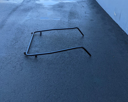CC-DS08+-FTS CLUB CAR DS 2008 AND NEWER MODEL FRONT TOP SUPPORT metal frame part shown on black asphalt surface against a blue wall background.