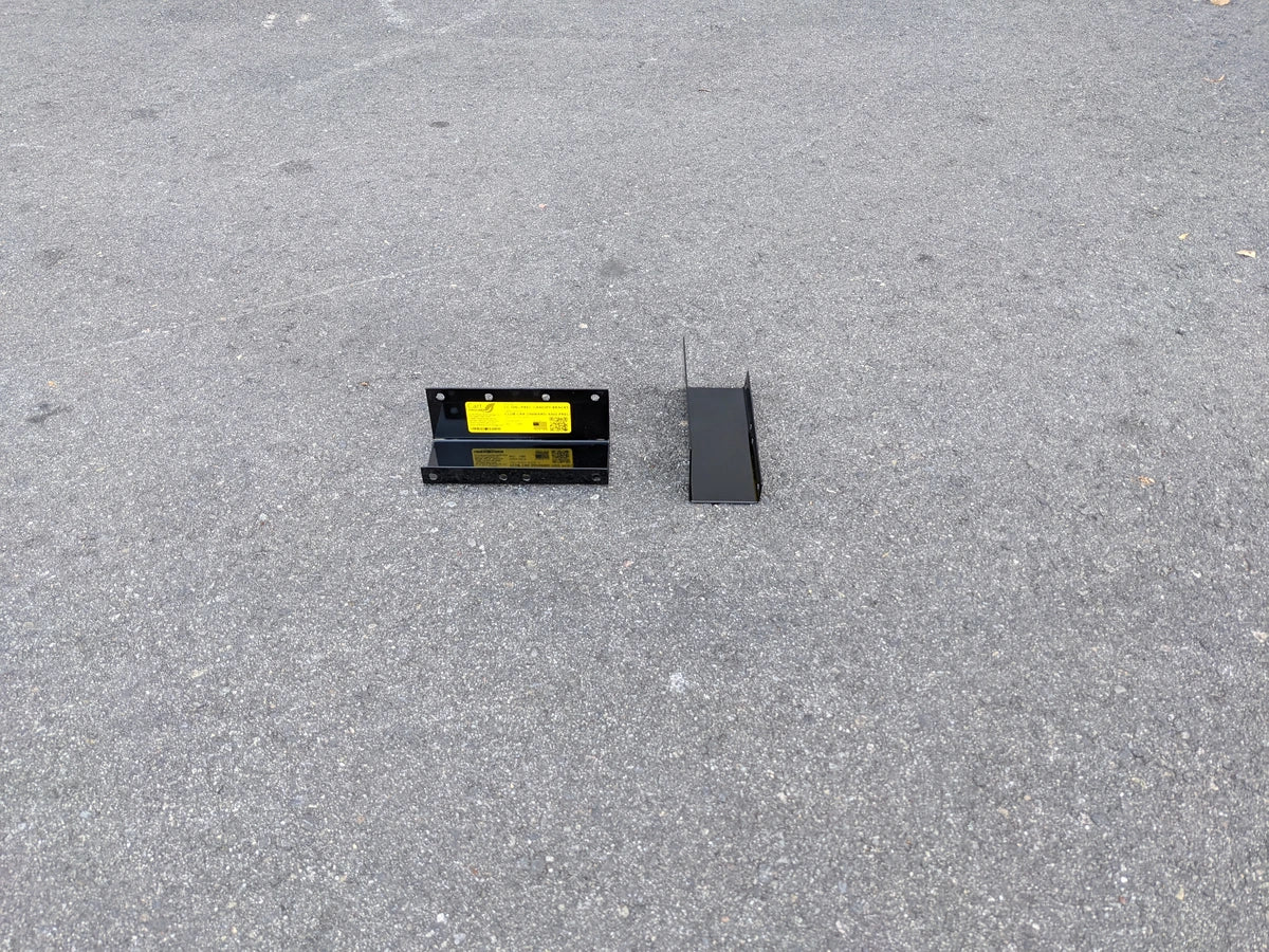 CC-ON+PREC-CANOPY BRACKET SET CLUB CAR ONWARD AND PRECEDENT SHADE TOP CANOPY BRACKET SET showing two black metal mounting brackets on pavement for golf cart accessories.