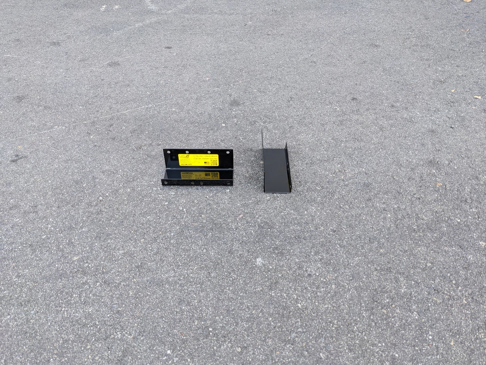 CC-ON+PREC-CANOPY BRACKET SET CLUB CAR ONWARD AND PRECEDENT SHADE TOP CANOPY BRACKET SET showing two black metal mounting brackets on pavement for golf cart accessories.