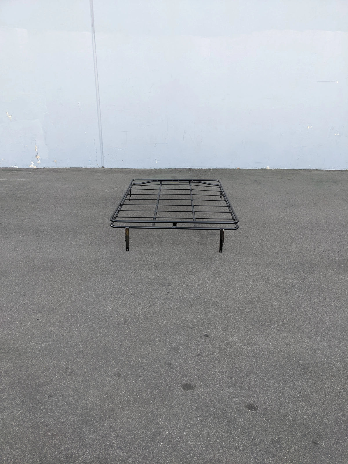 EZGO-S4CURVED-64RR3 ROOF RACK FOR EZ GO EXPRESS S4 shown outdoors on pavement, black metal rack designed with custom fabrication for golf carts to carry cargo or accessories.