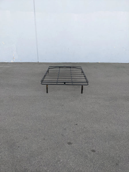 EZGO-S4CURVED-64RR3 ROOF RACK FOR EZ GO EXPRESS S4 shown outdoors on pavement, black metal rack designed with custom fabrication for golf carts to carry cargo or accessories.