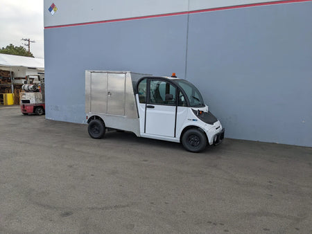 Small utility vehicle equipped with FMB-GEM-52X70X48-D-D2W0 Multi-Purpose Box for Flatbed, custom fabricated for golf carts, ideal for cargo and utility transport.