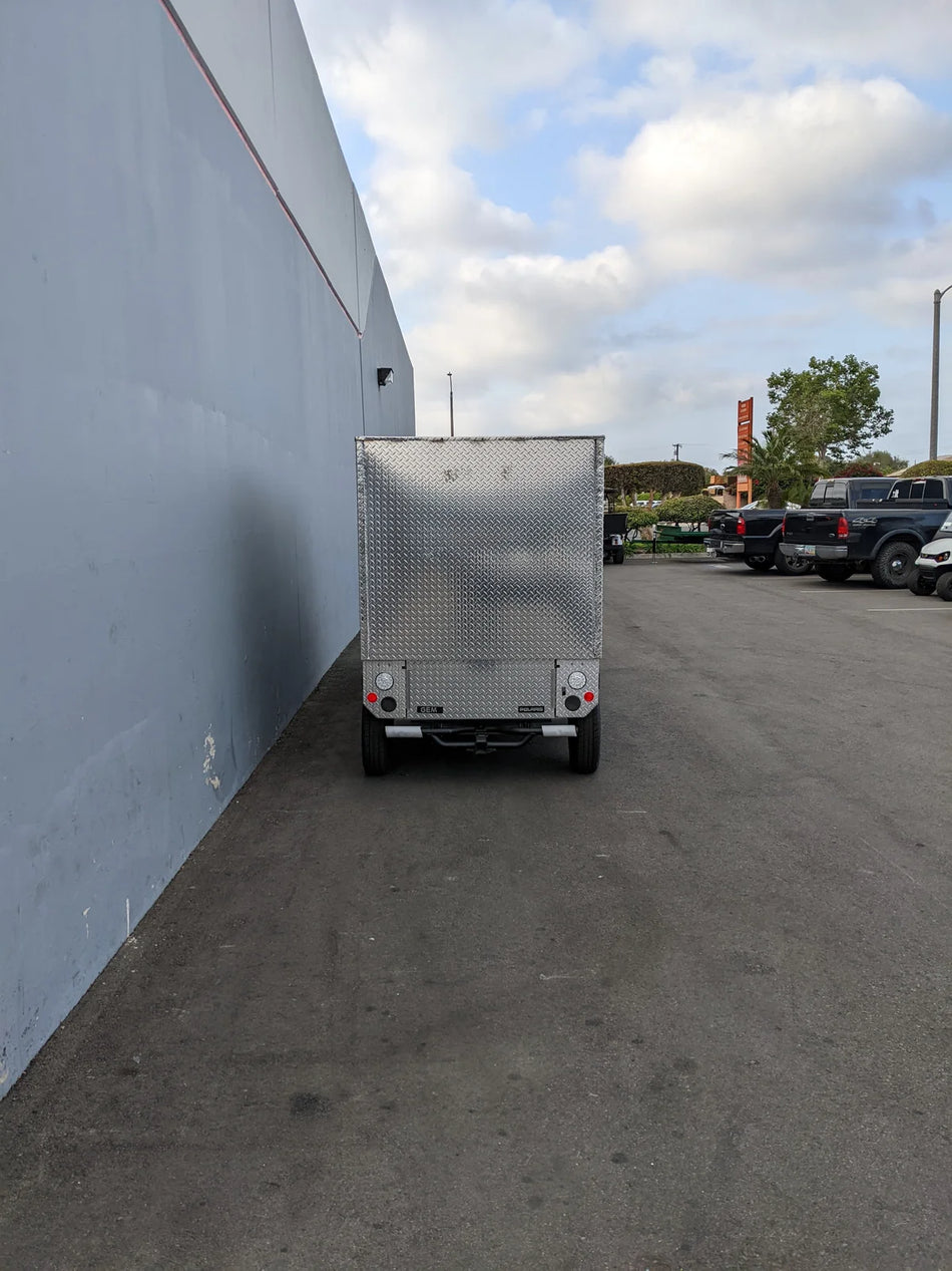 Rear view of the FMB-GEM-52X70X48-D-D2W0 Multi-Purpose Box for Flatbed mounted on a golf cart, showcasing custom fabrication designed for utility and cargo transport.