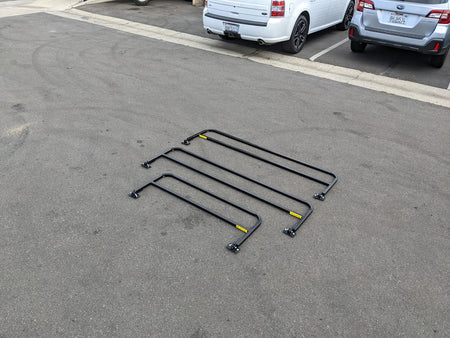 DROP RAILS 48″ X 66″ X 18″ FOR 5-1/2 FT FLATBED CONVERSION shown outdoors, four black metal rails designed as custom fabrication for golf carts, ideal for flatbed cargo and utility use.