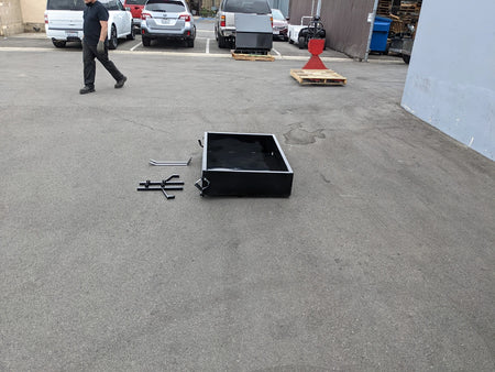 YAM-DRIVE-UTIL31 YAMAHA DRIVE HEAVY-DUTY INDUSTRIAL UTILITY BOX WITH TAILGATE shown on pavement with assembly parts nearby, custom fabrication designed for golf carts.