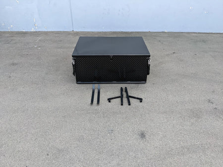 Black heavy-duty metal locking cargo box with mounting brackets on concrete surface, designed as YAM-DRIVE-CARGO31 YAMAHA DRIVE LOCKING CARGO BOX, custom fabrication for golf carts.