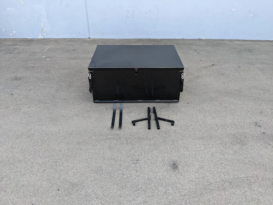 Black heavy-duty metal locking cargo box with mounting brackets on concrete surface, designed as YAM-DRIVE-CARGO31 YAMAHA DRIVE LOCKING CARGO BOX, custom fabrication for golf carts.