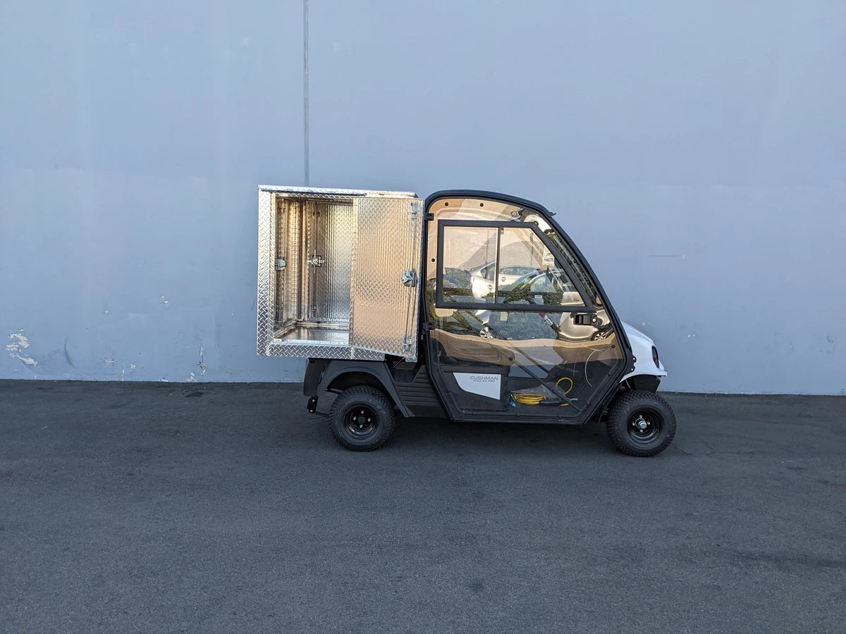 CUSH-HP-CARGO42X48X42-4D CUSHMAN HAULER PRO WITH CAB CARGO BOX WITH LOCKING DOORS custom fabrication for golf carts featuring a secured aluminum utility cargo box and enclosed cabin.