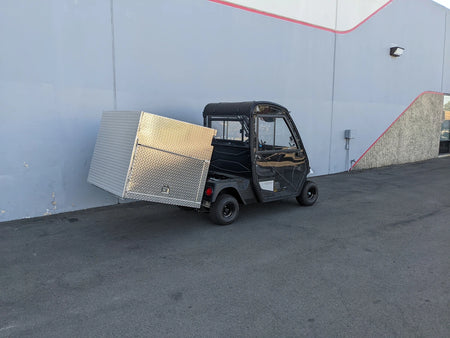 Black utility golf cart equipped with a custom fabricated aluminum cargo box with locking doors, showcasing the CUSH-HP-CARGO42X48X42-4D CUSHMAN HAULER PRO WITH CAB CARGO BOX WITH LOCKING DOORS.
