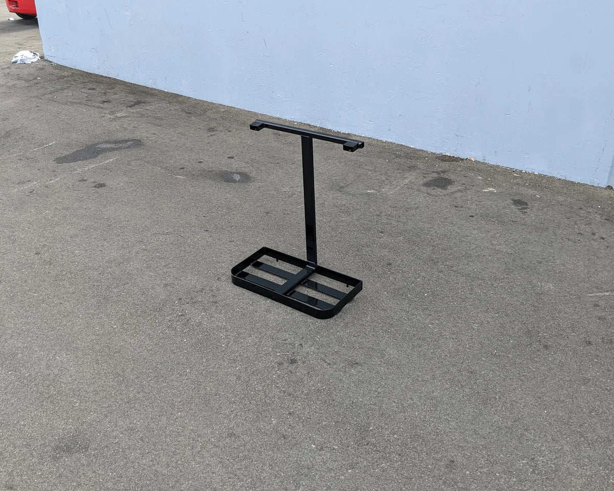 Black metal frame RAINBOW-BAG-RACK standing on pavement, designed for custom fabrication on golf carts as a specialty golf cart accessory.