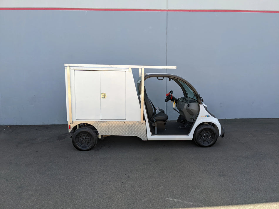 FMB-GEM-52X70X48-SL-D3W3 FLATBED ALUMINUM SMOOTH MULTI-PURPOSE LIGHT BOX FOR GEM ELXD 52″ WIDE X 70″ LONG X 48″ TALL WITH LOCKING DOORS installed on a custom fabrication golf cart for versatile cargo and utility transport.
