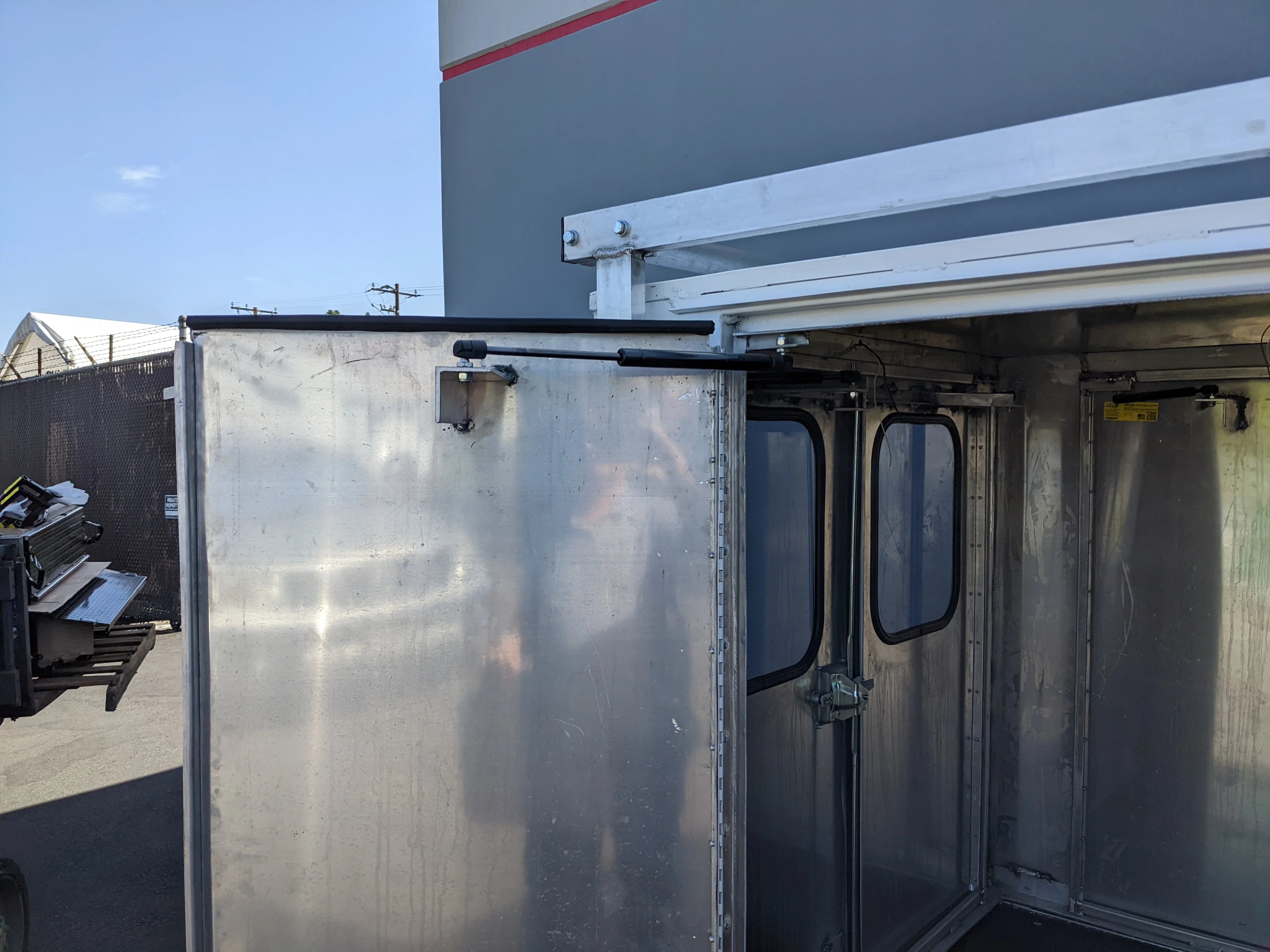 FMB-GEM-52X70X48-SL-D3W3 FLATBED ALUMINUM SMOOTH MULTI-PURPOSE LIGHT BOX FOR GEM ELXD 52″ WIDE X 70″ LONG X 48″ TALL WITH LOCKING DOORS shown open, custom fabrication for golf carts with durable aluminum construction and secure locking doors.