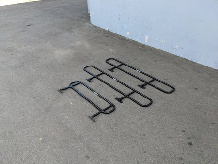 DROP RAILS CUSH-TITAN CUSHMAN TITAN DROP RAILS SET WITH BRACKETS displayed on pavement, custom fabrication for golf carts, designed for utility and durability.