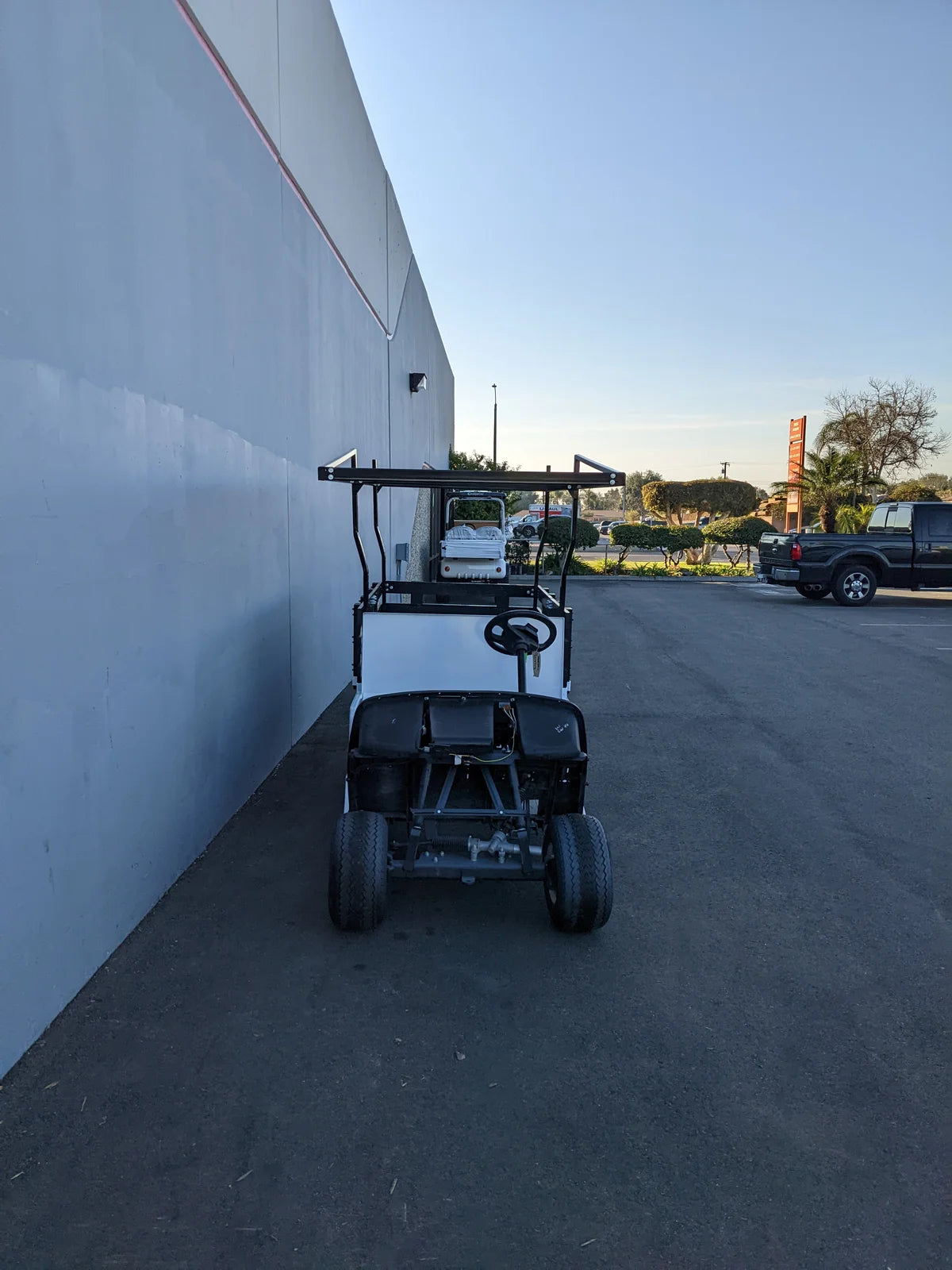 Golf cart with STAKE-SIDES-44X72X18 Flatbed Golf Cart Stake Sides installed, showcasing custom fabrication for enhanced cargo and utility transport on a flatbed.