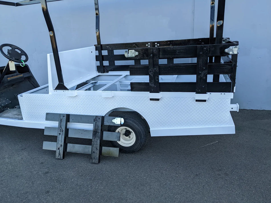STAKE-SIDES-44X72X18 Flatbed Golf Cart Stake Sides installed on a white flatbed golf cart with black metal side panels and an attached black ladder, showcasing custom fabrication for golf carts.