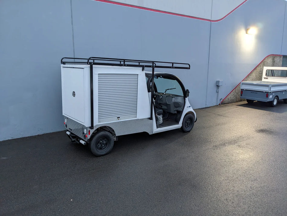 GEM-ELXD-53X120-TLR Top Mount Ladder Rack for outside mount on a GEM ELXD installed on a white utility golf cart with custom fabrication for golf carts, featuring cargo and specialty racks.