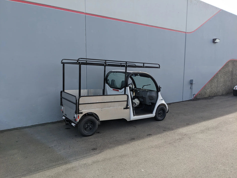 Custom fabricated DROP RAILS GEM ELXD SOL SOLID SIDE RAILS FOR GEM ELXD installed on a golf cart flatbed for secure cargo transport and utility use.