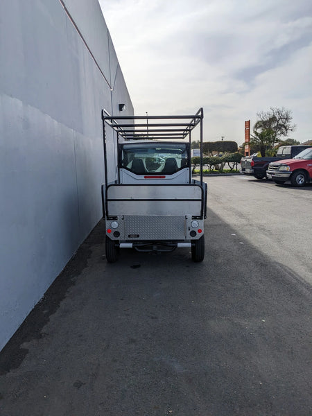 Rear view of a golf cart equipped with DROP RAILS GEM ELXD SOL SOLID SIDE RAILS FOR GEM ELXD, designed for custom fabrication and utility cargo transport.