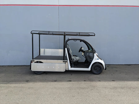 White utility golf cart with flatbed and black metal frame featuring DROP RAILS GEM ELXD SOL SOLID SIDE RAILS FOR GEM ELXD custom fabrication for golf carts