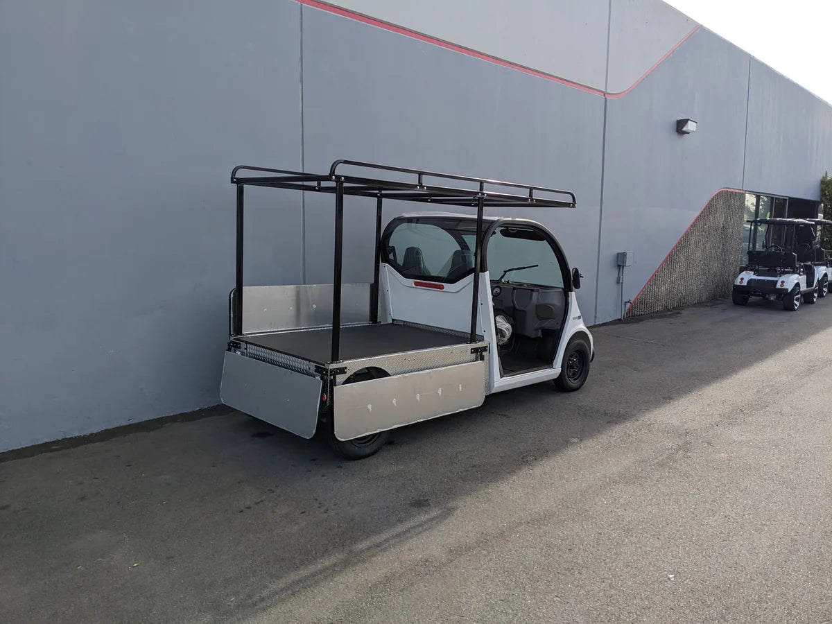 White golf cart equipped with GEM-ELXD-53X120-IN-TLR Top Mount Ladder Rack for mounting inside the bed of a GEM ELXD, designed for custom fabrication for golf carts.