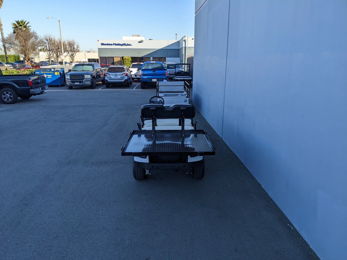 CUSH-SHUTTLE-DECK48X48-SP CUSHMAN SHUTTLE CARGO DECK WITH STAKE POCKETS installed on a golf cart, showcasing custom fabrication for golf carts designed for cargo and utility transport.