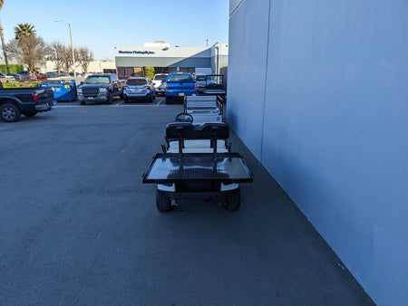 CUSH-SHUTTLE-DECK48X48-SP CUSHMAN SHUTTLE CARGO DECK WITH STAKE POCKETS installed on a golf cart, showcasing custom fabrication for golf carts designed for cargo and utility transport.